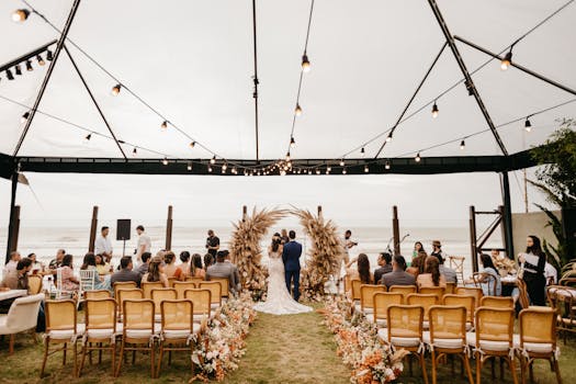 A picturesque wedding ceremony held outdoors under a canopy by the sea. Perfect setting for a romantic event.